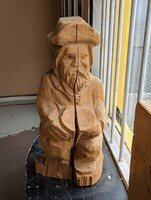 Wood-Carved hat man with a log statue