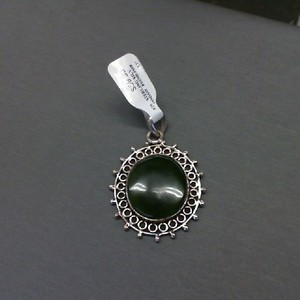 Oval dark green jade set is sterling silver filigree pendant