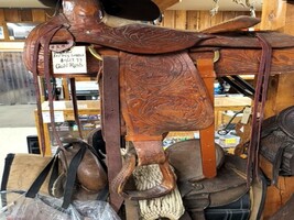 INTRICATELY TOOLED ROPING SADDLE
