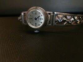 YANKA RUSSIAN WATCH WITH BLUE STONES SET IN BAND.