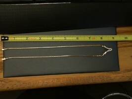 . .14K YELLOW GOLD NECKLACE WITH 17 DIAMONDS .03CT EA SET IN A V SHAPE