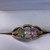  1 OVAL GREEN STONE - 1 OVAL CLEAR STONE - 1 OVAL PINK STONE  BRAIDED EDGED RING