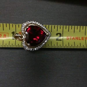  10K YELLOW GOLD HEART PENDANT WITH RED STONE CENTER 6EA .01CT DIAMONDS AROUND