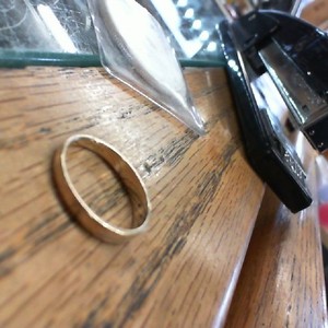 . .THIN GOLD BAND WITH 3 DIAMOND CHIPS