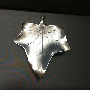 . .STERLING SILVER PIN SHAPED AS A MAPLE LEAF