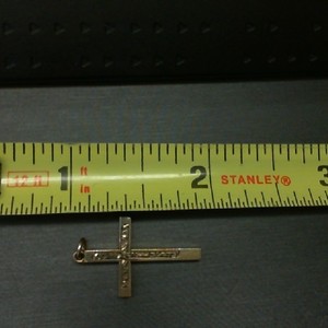  10K YELLOW GOLD CROSS PENDANT WITH ENGRAVED DESIGN ON FRONT