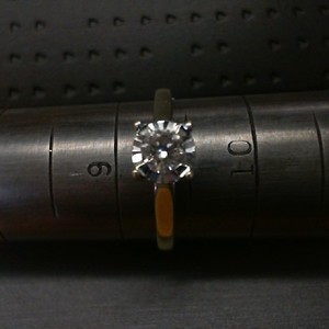 . .10K WHITE GOLD RING WITH .40CT DIAMOND AND 2 .10CT DIAMOND