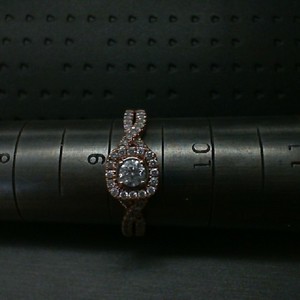  10K ROSE GOLD ENGAGEMENT RING WITH .15 DIAMOND HALO SETTING WITH TWISTED BAND