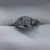  10K WHITE GOLD WITH .20CT CENTER DIAMOND WITH 2EA  .05CT ACCENT DIAMONDS