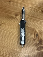 OTF KNIFE WITH SKULLS