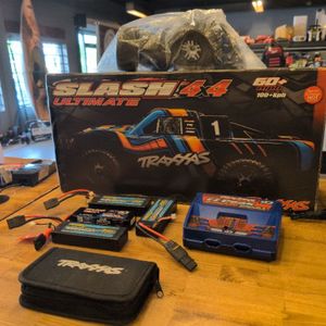 TRAXXAS SLASH 4X4 ULTIMATE W/ 4 BATTERIES, CHARGER, AND XTRA WHEELS