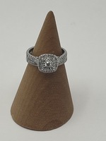 10K WHITE GOLD RING WITH .10 ROUND CENTER DIAMOND SURROUNDED BY DIAMONDS 