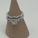 10K W/G SET ENGAGMENT DIA CHIPS ACROSS FACE BAND HAS .30 CENTER DIAMOND SURROUND