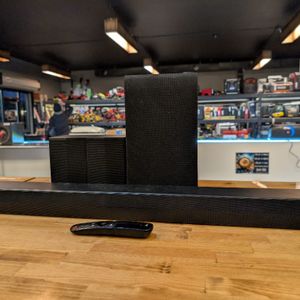 LG S55TR SOUNDBAR WITH 2 SPEAKERS, A SUB, AND THE REMOTE