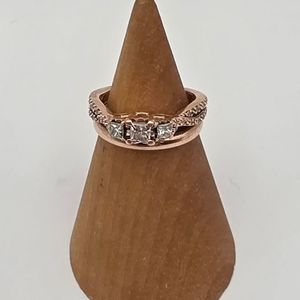 14K ROSE GOLD RING WITH .15 PRINCESS CENTER DIAMOND AND .10 PRINCESS DIAMOND ON 