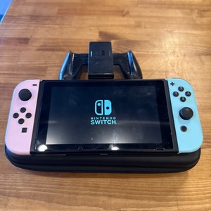 NINTENDO SWITCH CONSOLE WITH CONTROLLER GRIP HANDLE AND CASE NO CHARGER, NO OTHE