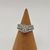 14K WHITE GOLD RING WITH .10 CENTER DIAMOND WITH HALO OF DIAMONDS AROUND SIZE 5