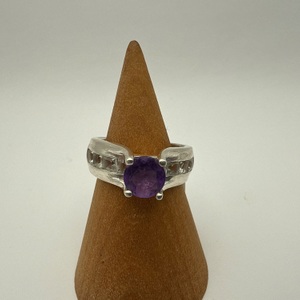 ring with purple stonee and clear stones on side SIZE 7 