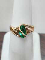 Green Marquise shape stone in tri-color mounting